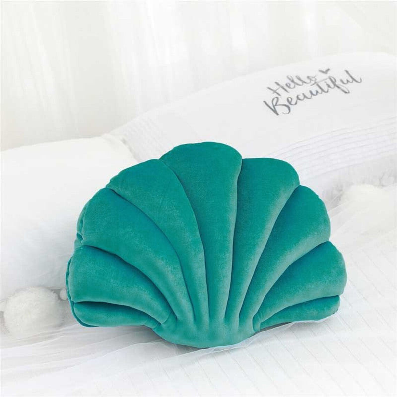  pillow with a shell shape, adding a touch of elegance and comfort to any space.