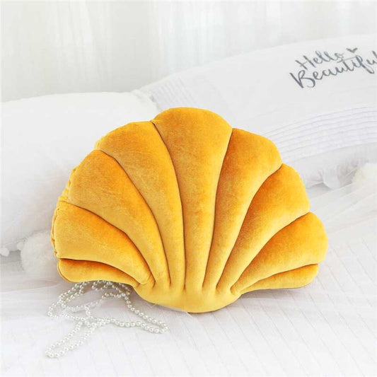  pillow with a shell shape, adding a touch of elegance and comfort to any space.