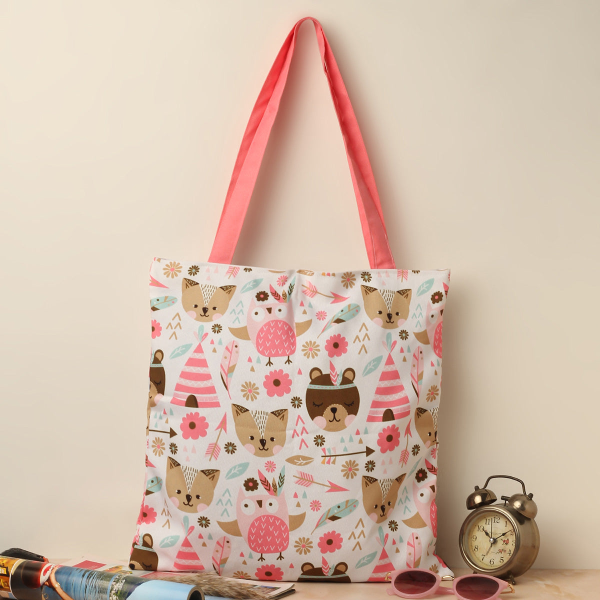 A tote bag adorned with adorable animals and vibrant flowers, perfect for adding a touch of cuteness to your everyday style.