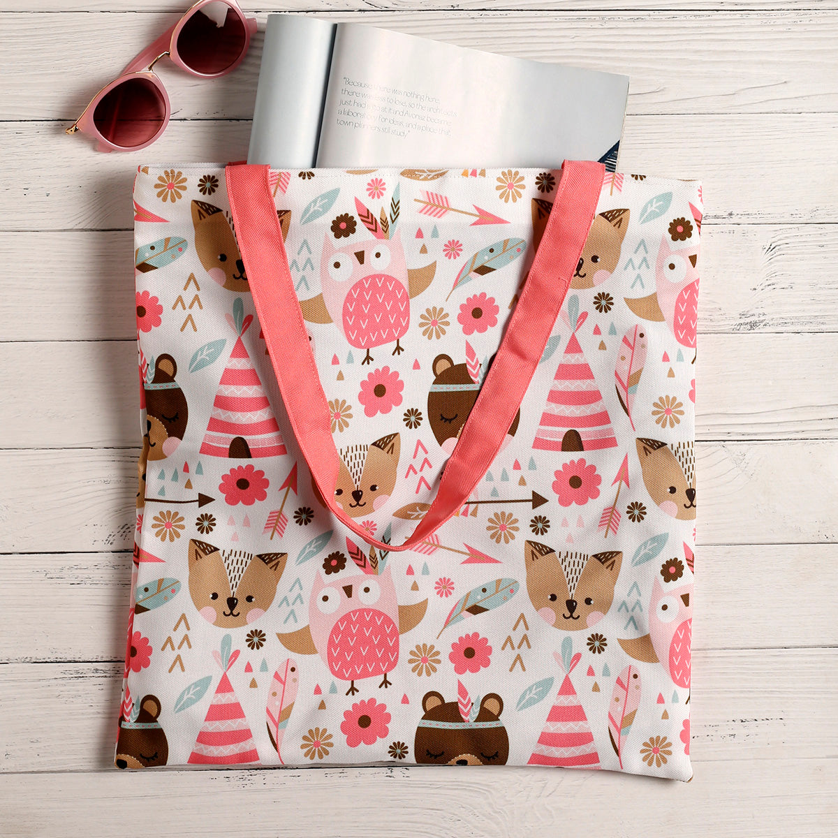 A tote bag featuring adorable animals and colorful flowers, perfect for adding a touch of whimsy to your everyday style.