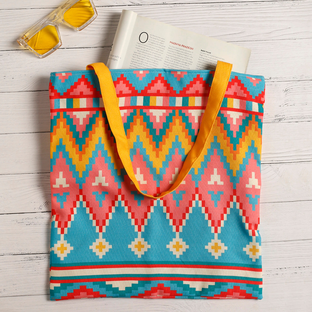 Vibrant tote bag featuring a geometric design with color yellow teal & red, ideal for carrying your essentials in style.
