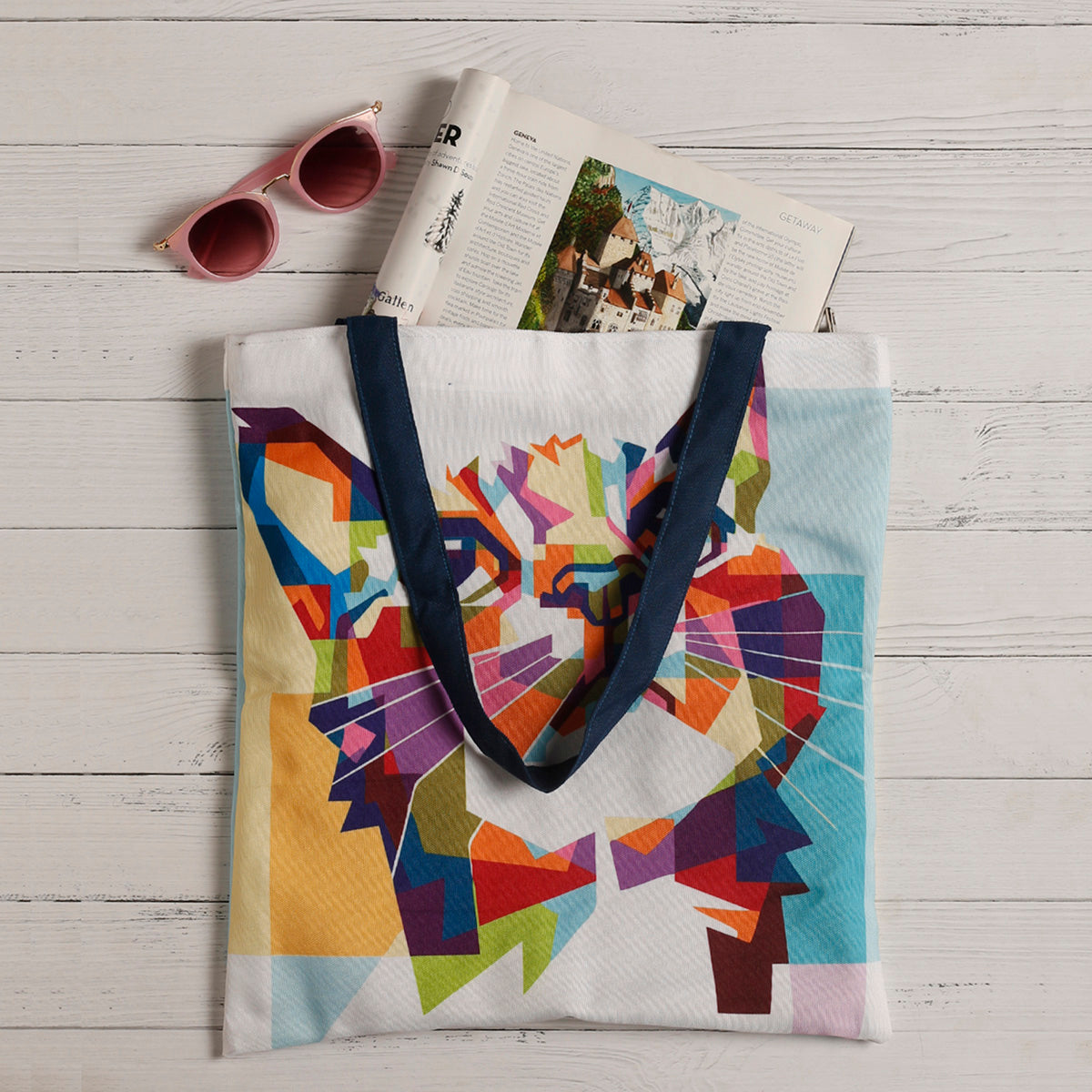 A vibrant tote bag featuring a cat face design in various colors. Perfect for cat lovers!