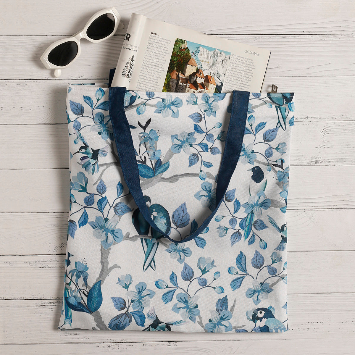 Stylish blue and white floral tote bag featuring a clock and books, ideal for a chic and practical look.