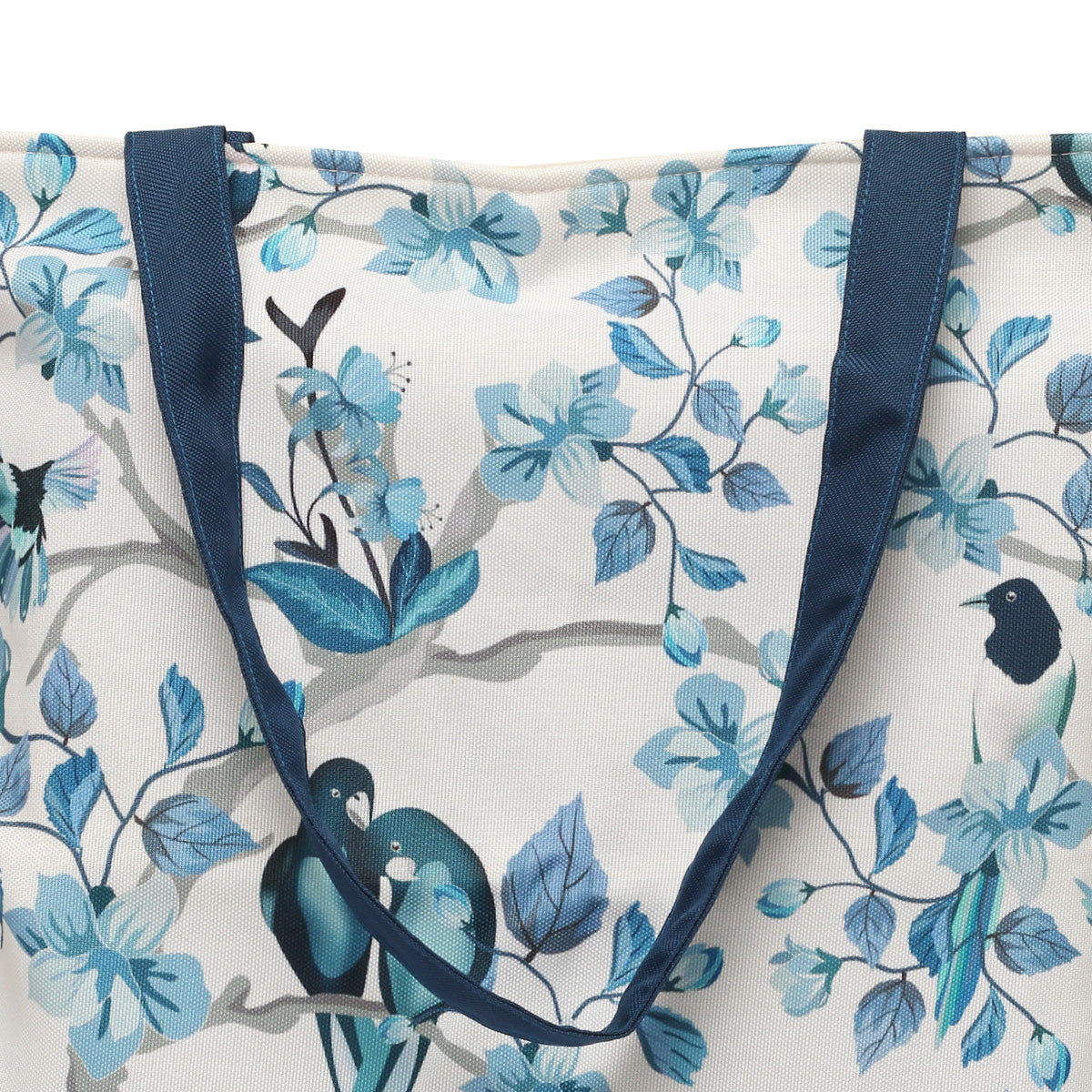 Zoom view of a stylish tote bag with blue and white colors, adorned with charming bird designs.