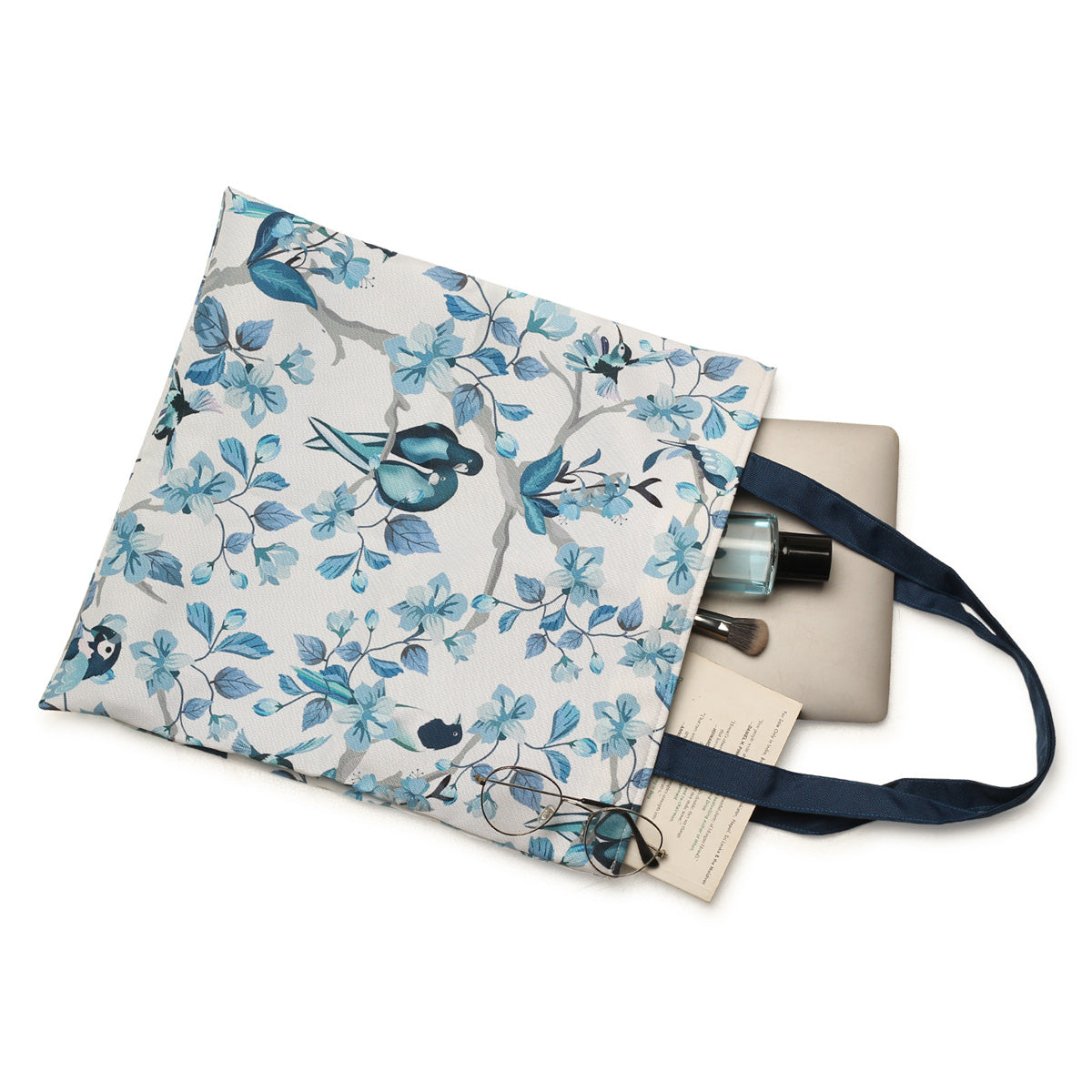 A stylish tote bag with blue and white colors, adorned with beautiful bird designs. Perfect for carrying your essentials in style!