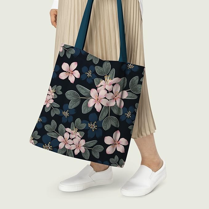 Women holding a  Black, blue and pink floral tote bag, perfect for adding a pop of color to your outfit.