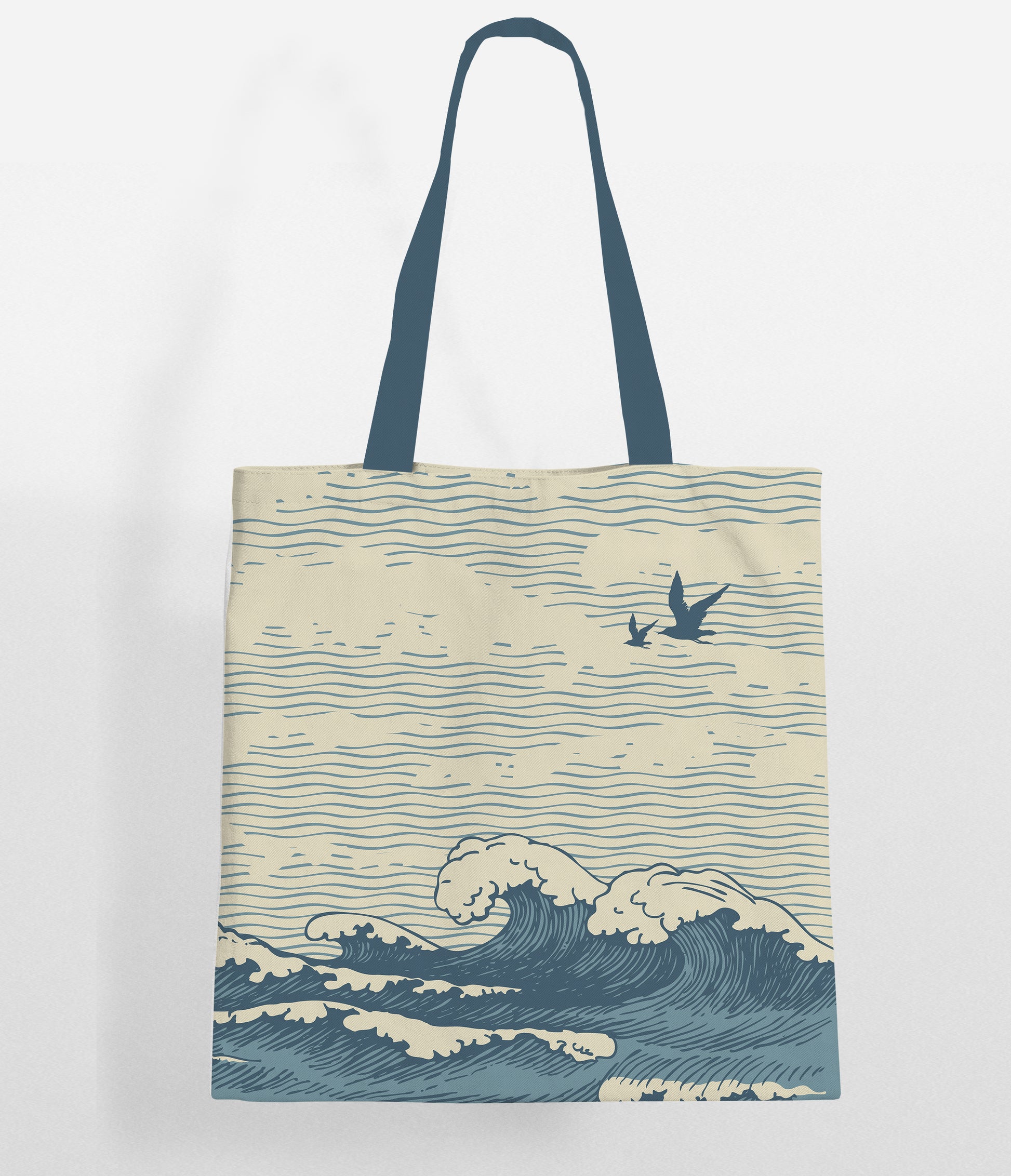 A beige tote bag with dark blue handles and a printed design featuring wavy lines representing the ocean, with two seagulls flying above the waves.