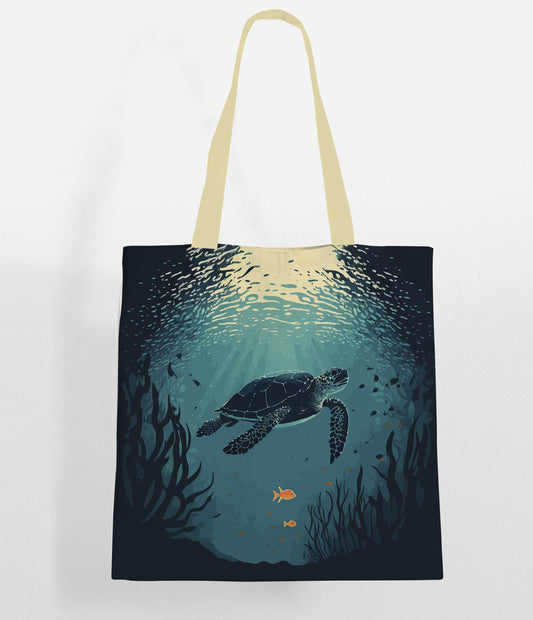 A tote bag with a design of a sea turtle swimming underwater with sun rays shining through the water's surface, surrounded by seaweed and a few small fish.