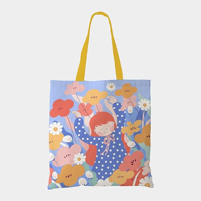 A tote bag featuring a girl joyfully standing amidst a vibrant flower field, capturing the essence of nature's beauty.