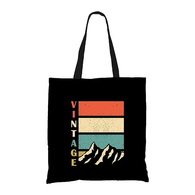 A chic black tote bag adorned with the words "vintage mountain," ideal for carrying your essentials in style.