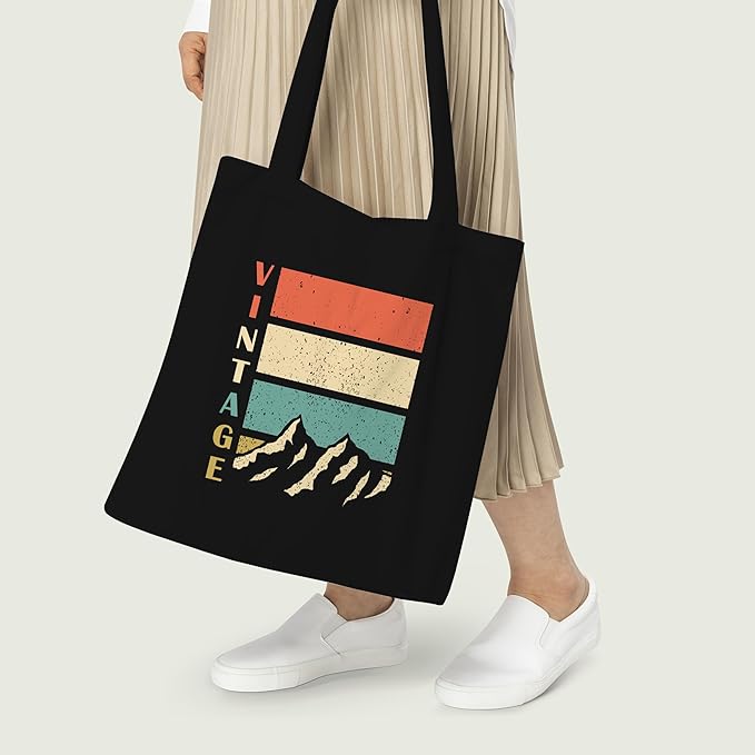 A sleek black tote bag showcasing "vintage mountain" text, combining fashion and functionality for any outing.