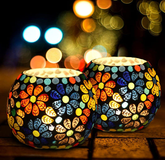 Two vibrant glass tealights adding a pop of color to a table.