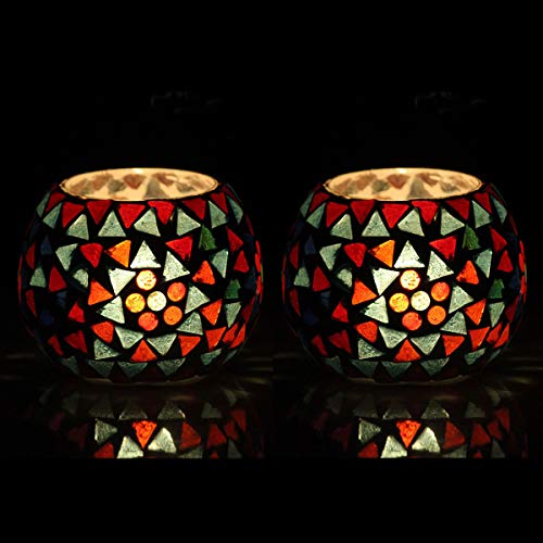 Two colorful glass tealights on black background.