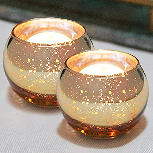 Gold tea lights displayed on table, enhancing the room's atmosphere.