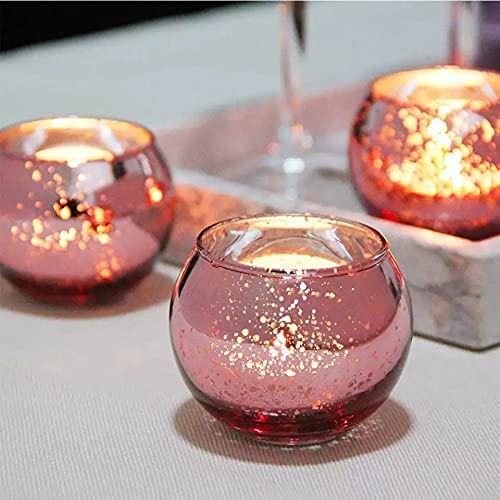 Two pink glass tealights on a tray, creating a soft and inviting atmosphere.