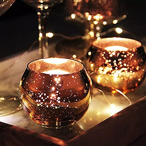 Two pink glass tealights on a tray.