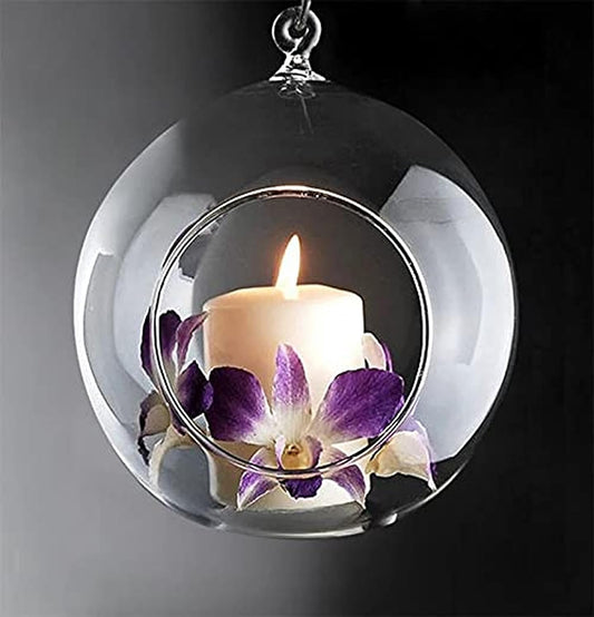  Glass ball with lit candle inside, creating a warm glow.