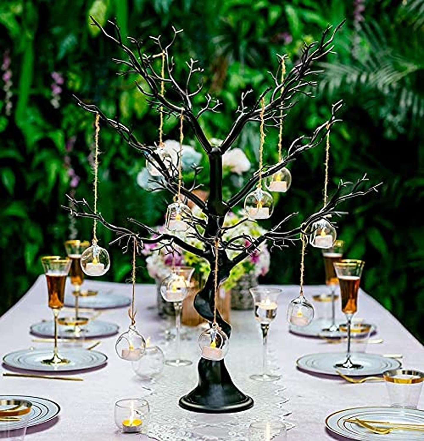  Elegant table decor featuring a tree and candles for a festive event.