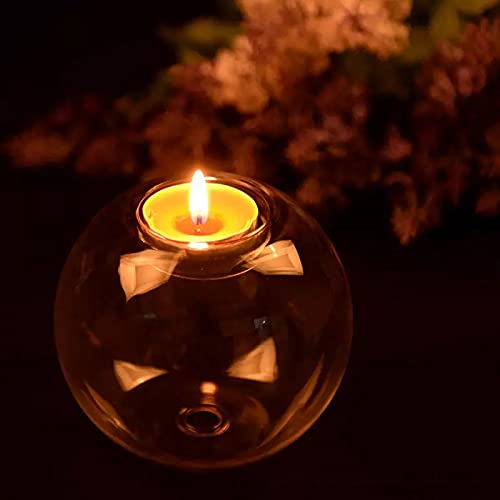  Set of three glass tealights with glowing flames.