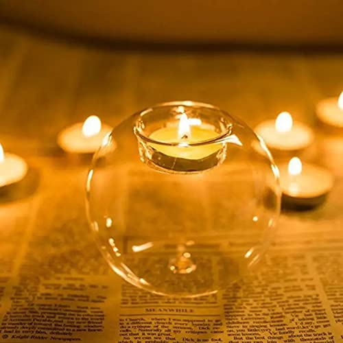  Trio of glass tealights illuminated by burning candles.