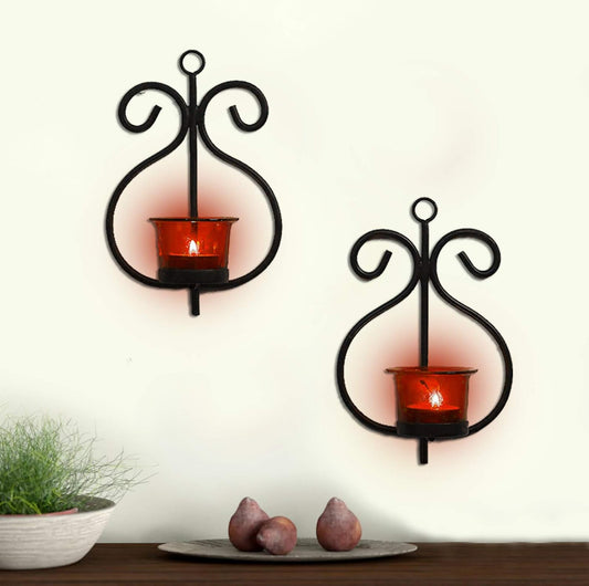 Two black wall sconces with red candles, adding a touch of elegance to the room decor.