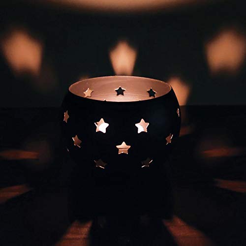 Elegant black candle featuring star patterns, great for ambiance.