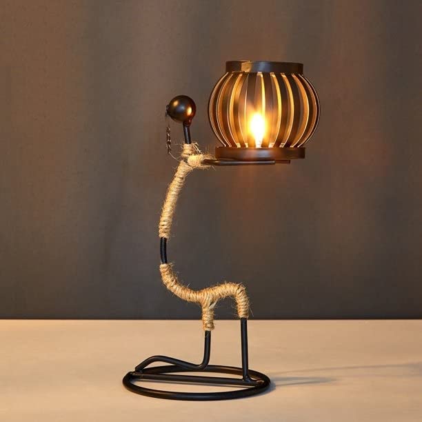 Metal cage lamp, industrial design, adds a unique touch to any room decor.