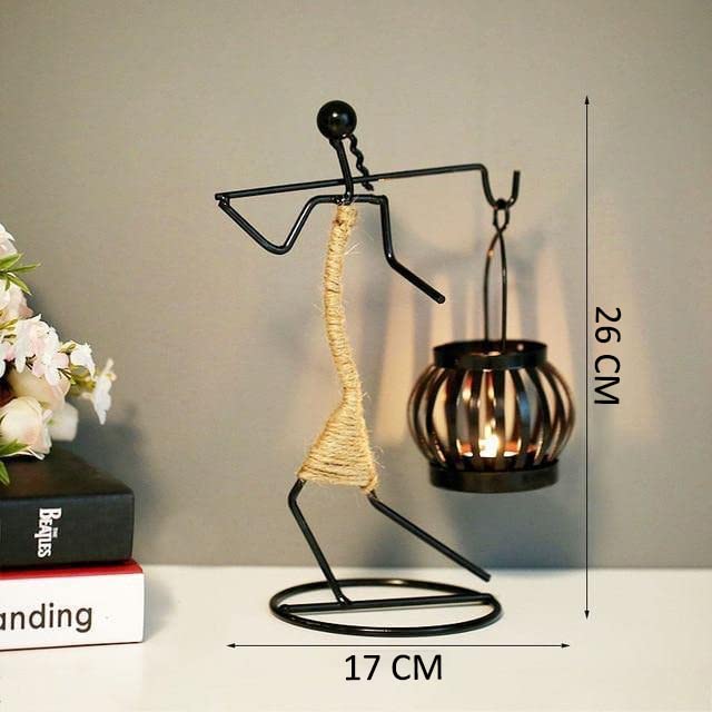 Sculpture made of metal with candle holder and candle.