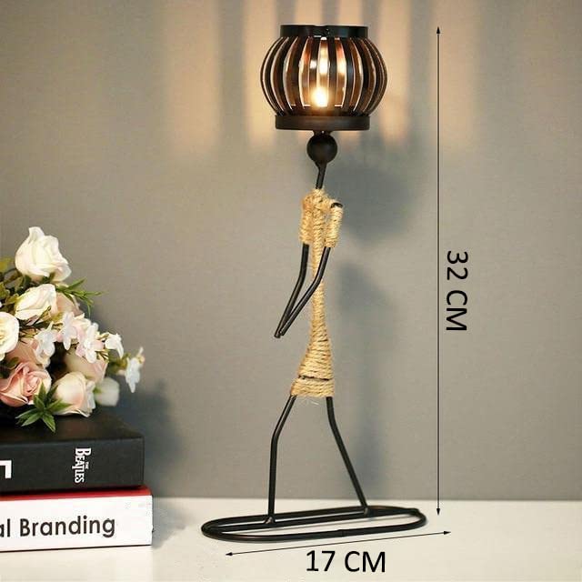 Candlestick holder with a metal stand and burning candle.