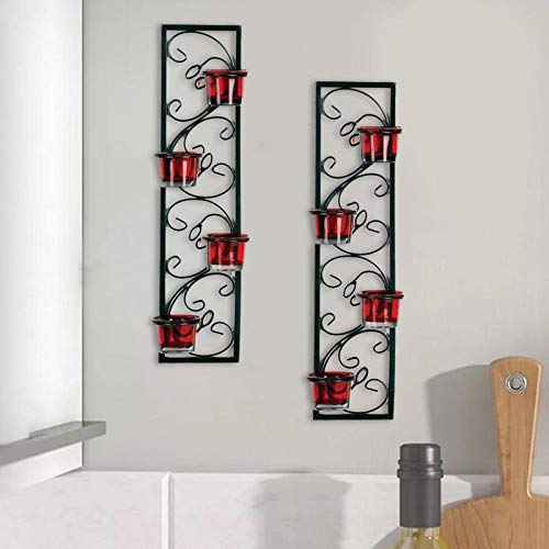 Pair of red and black candle holders on wall.