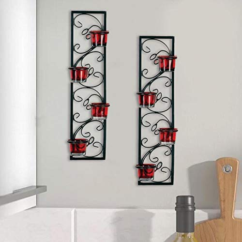  Two candle holders in red and black on wall.