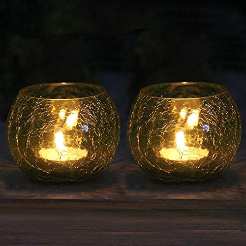 Two glowing tealights in the dark