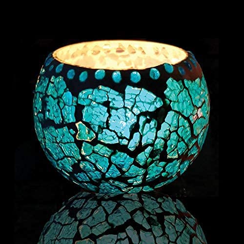 A tealight holder crafted from blue glass with a crackled design.