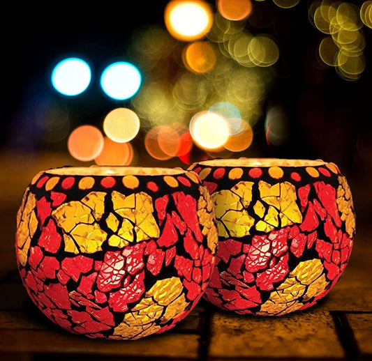 Bright red and yellow tealights on a dark base.