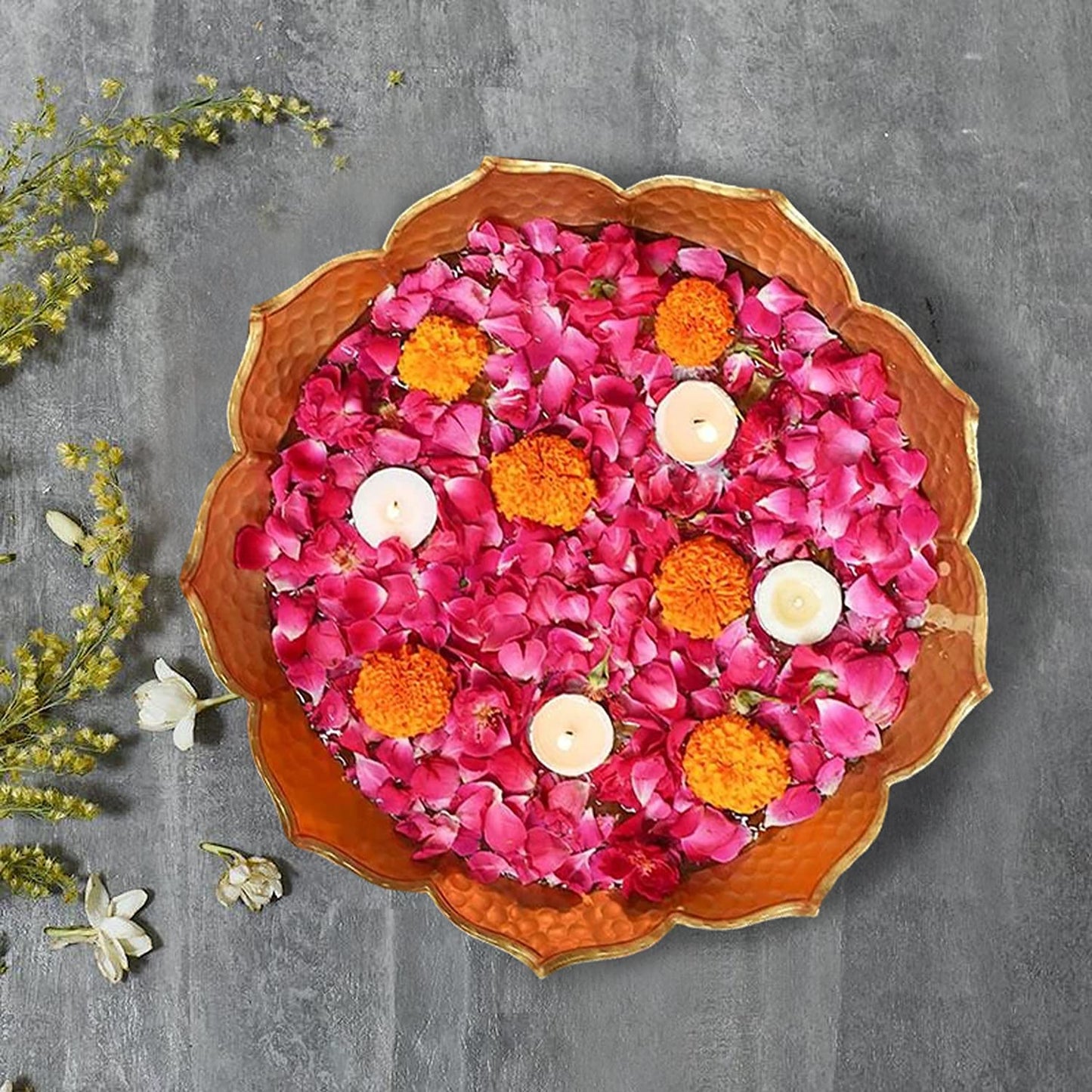 Elegant floral centerpiece with candles and vibrant flowers.