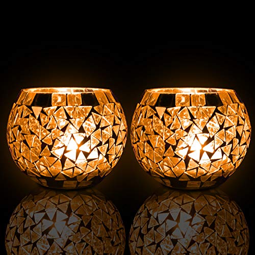 Two gold tea lights against a black background