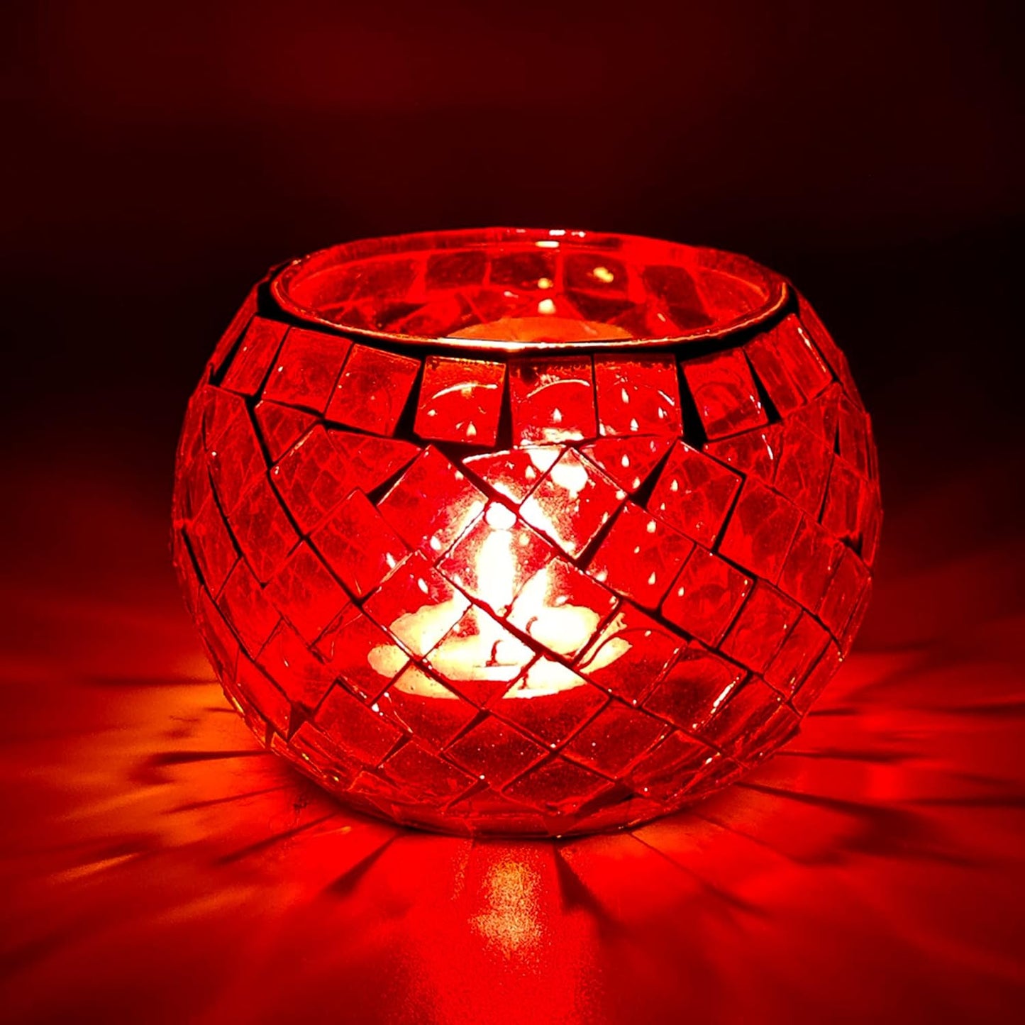 A single red glass tealight holder.