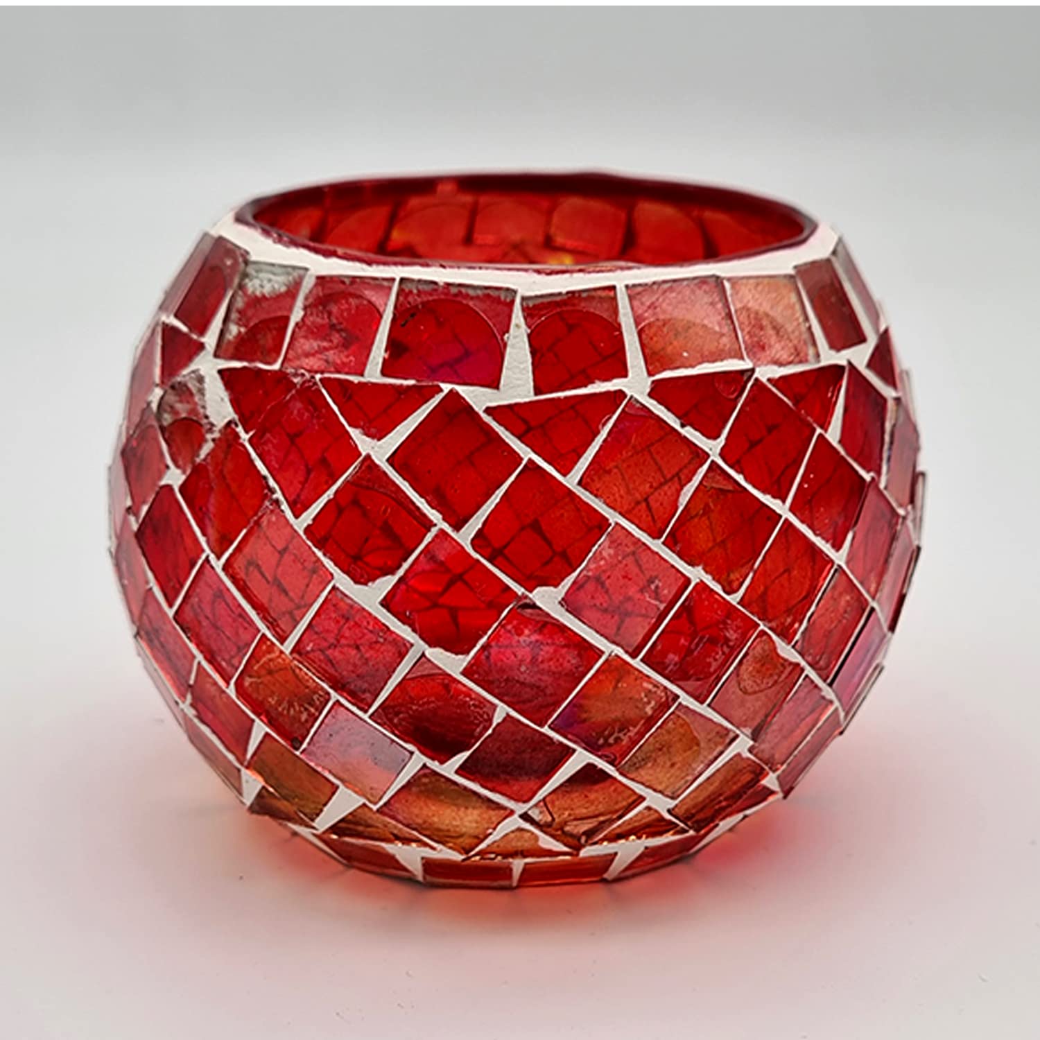 A red glass vase with a mosaic pattern.