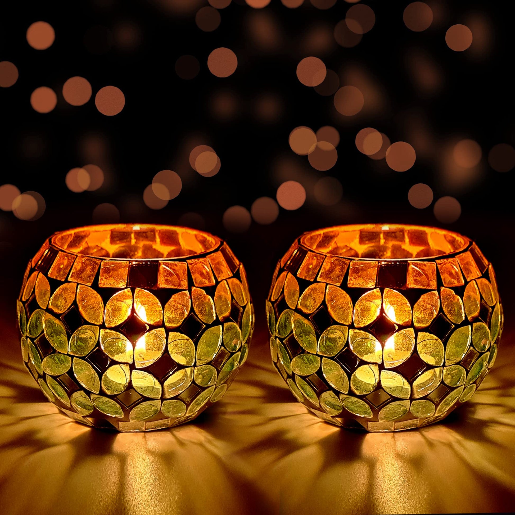 Two golden candles glowing brightly on a dark background.