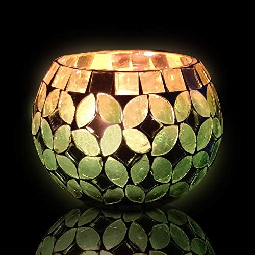  Decorative glass candle holder with gold leaf motif in green and gold.