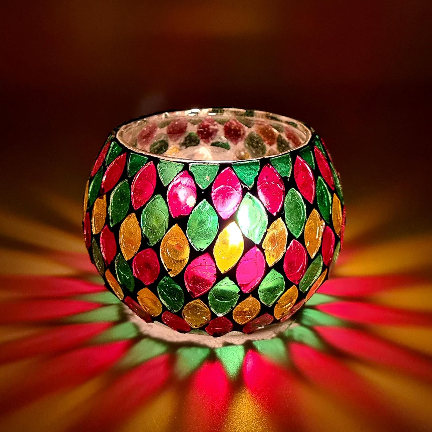 Colorful glass candle holder with bright light illuminating the room