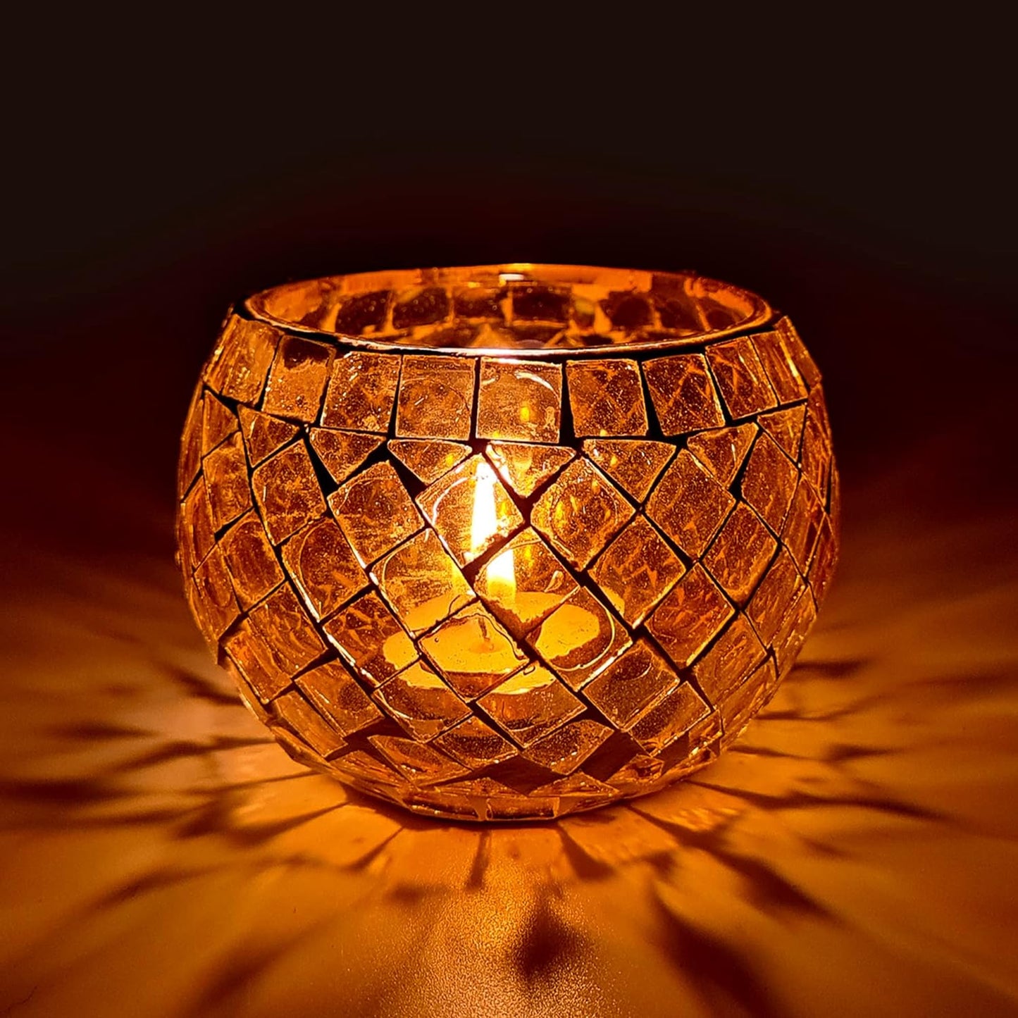  Glass candle holder with glowing light inside.