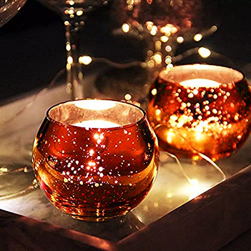 Two tealight candles on tray with glass of wine.