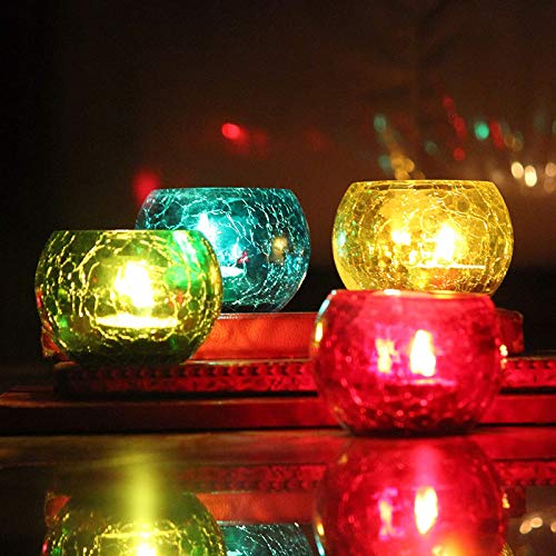 Colorful glass tealights arranged on a table.