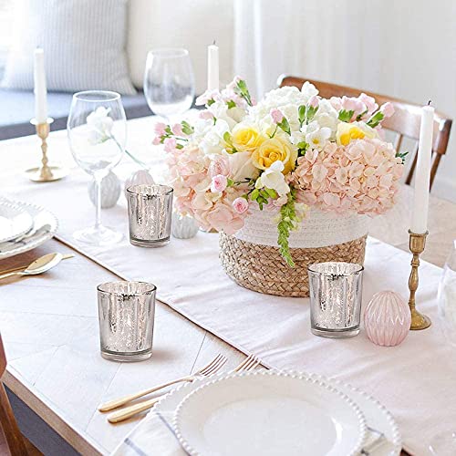 A table set with silverware and flowers.