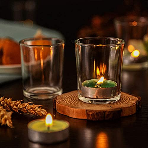 Four glass votive candles on wooden stand, creating warm ambiance.