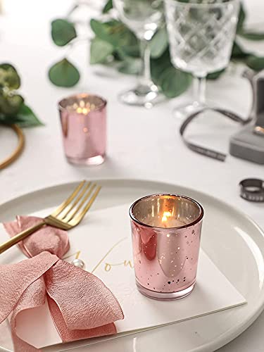 A pink candle on a white plate.