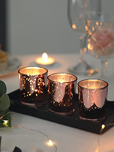  Elegant display of three candles and glass vase on a tray.