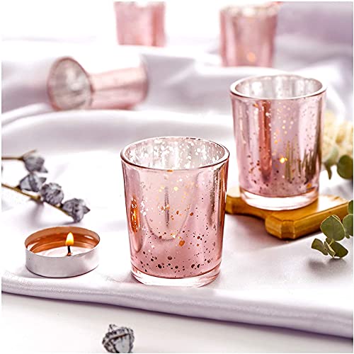 Pink tea lights with candle and flowers, creating a cozy and romantic atmosphere.