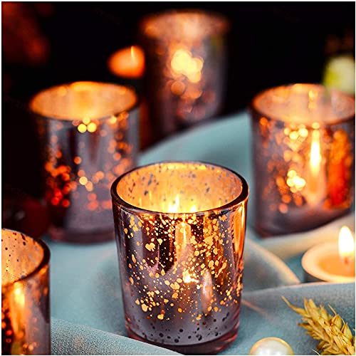 A candle holder and four glass votive candles arranged on a table.